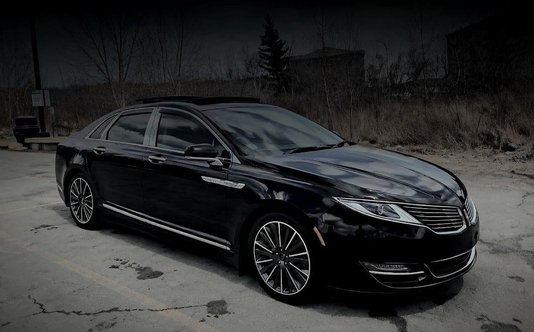 The black Lincoln sedan used by Jae’s Private Car Service, seen from the front three-quarter