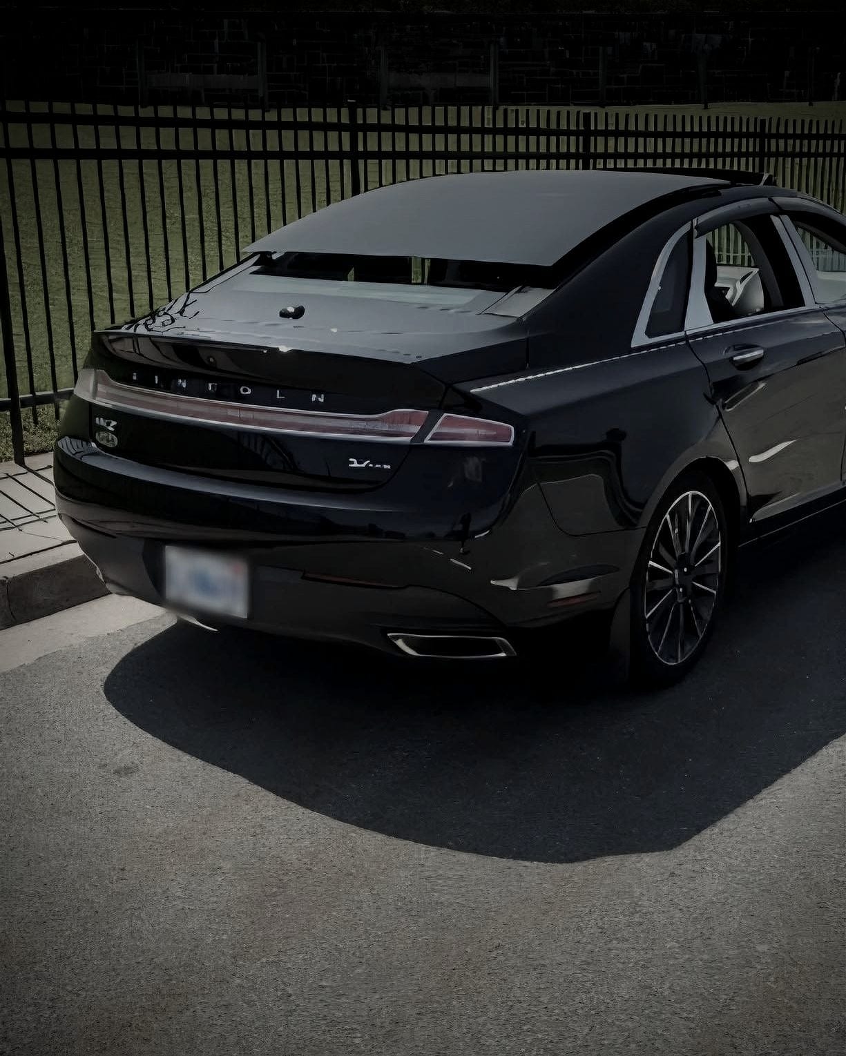 Rear three-quarter view of the black Lincoln